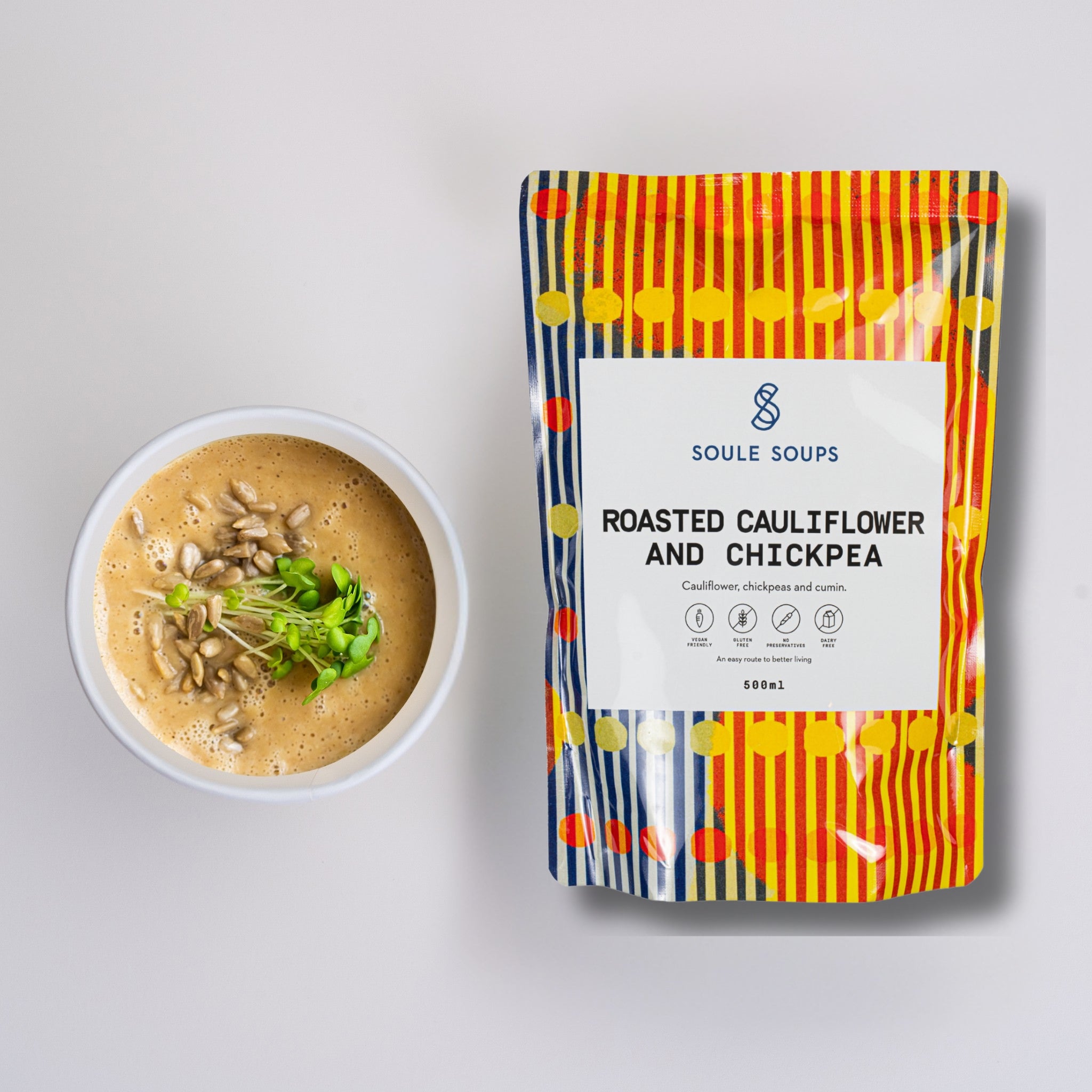 Soul Soups roasted cauliflower and chickpea soup package with a bowl of soup on a light gray background
