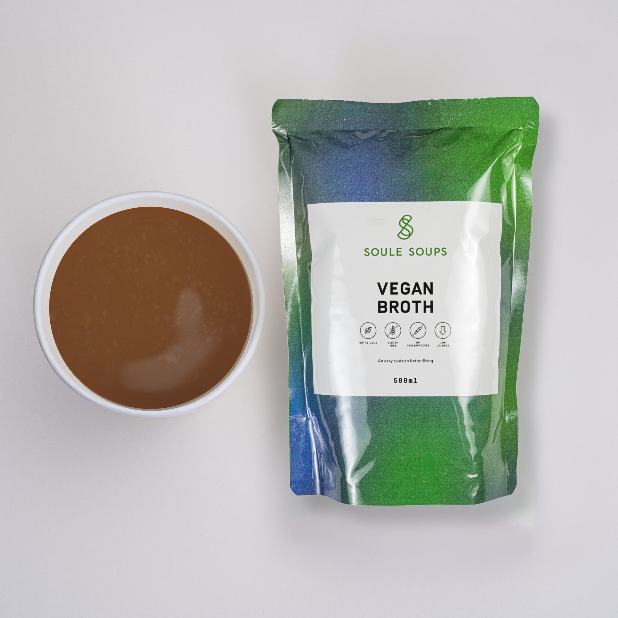 Soule Soups Vegan Broth package with a bowl of broth on a light gray background